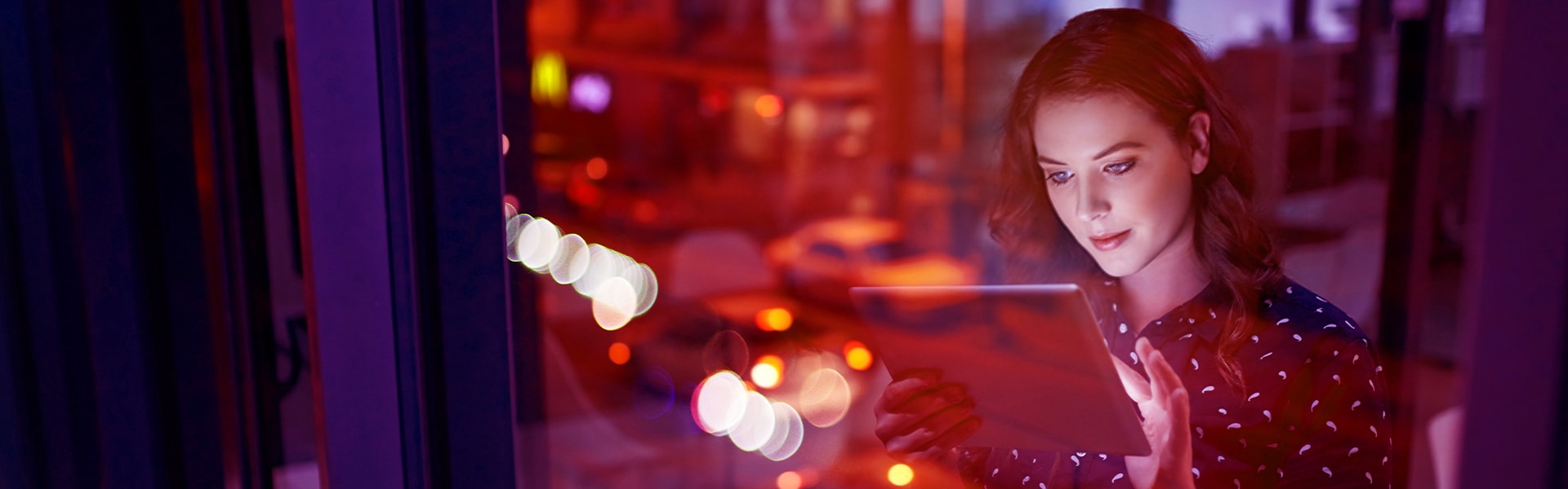 Woman on an ipad through a window