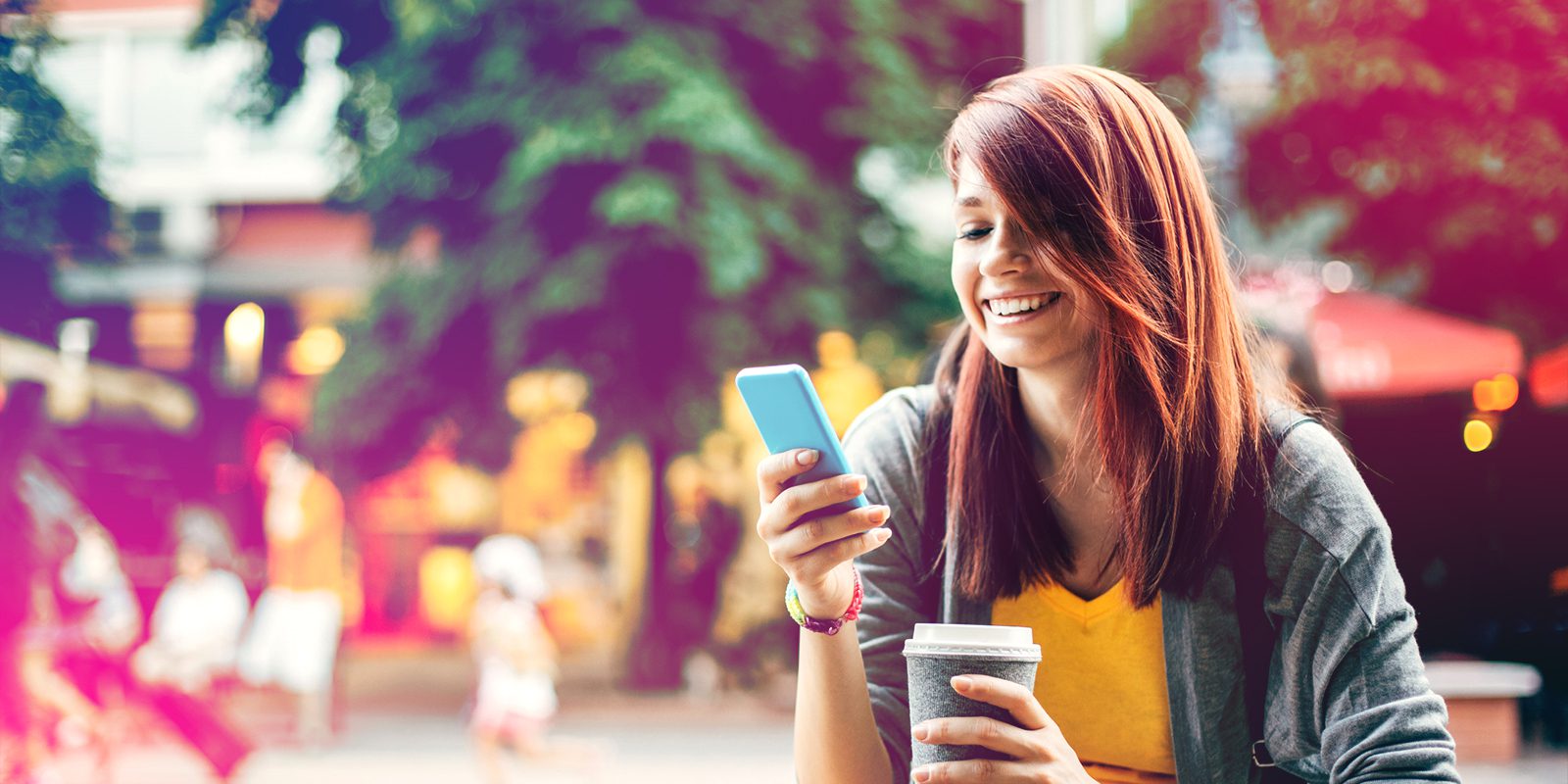 Woman holing phone drinking coffee