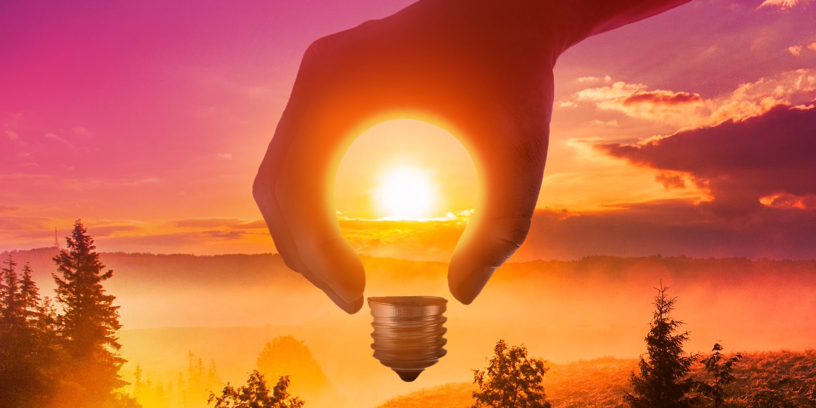 Hand holding a lightbulb with the sun as the light